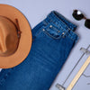 Denim jeans, hats, and glasses on table